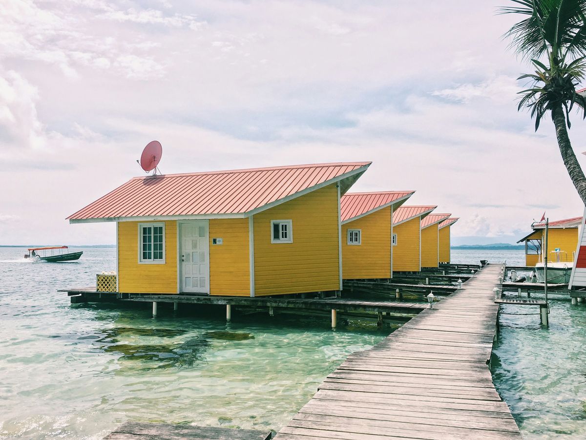 Yellow cabins on stilts over shallow water in Bocas del Toro