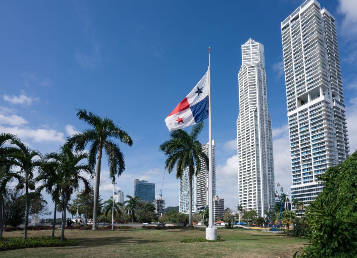 Panama City's skyscrapers behind a park with palm trees
